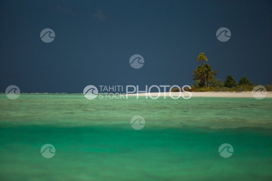 Bora Bora, Small island with coconut trees and white sand beach in the lagoon