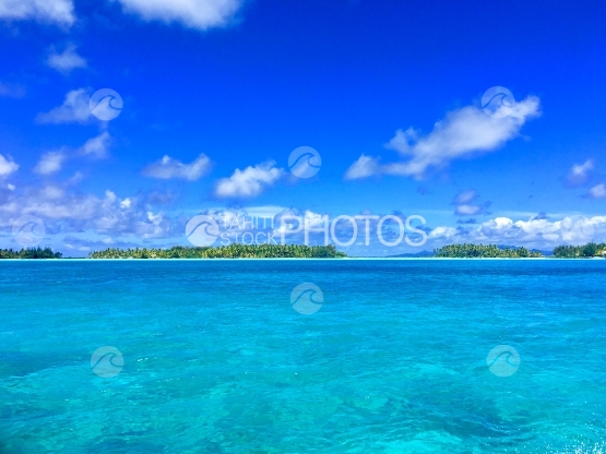 Blue water and Motus in the beautiful lagoon of Bora Bora