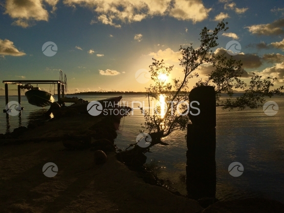 Fisher boat in the lagoon of Tahaa during early sunset