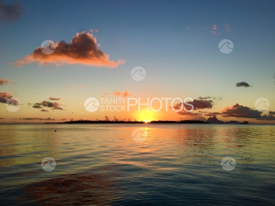 Sunset in the lagoon of Tahaa, Bora Bora, in the background