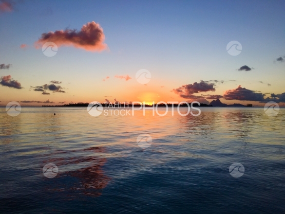 Sunset in the lagoon of Tahaa, Bora Bora in the background