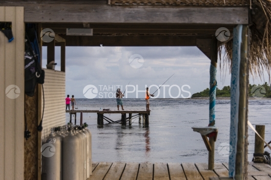 Fakarava, fisher men on the wooden deck near a dive shop