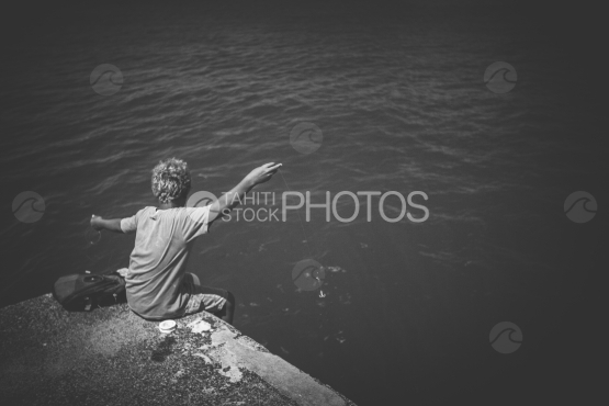 Young polynesian fishing on the pear