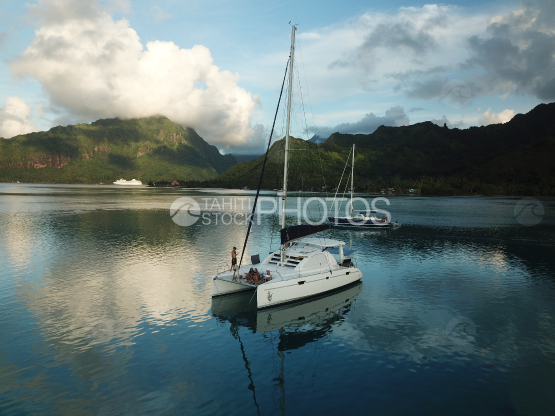 Moorea, sail boats anchored in the lagoon, with passengers on board