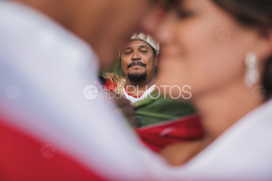 Polynesian preacher celebrating the traditional wedding of couple of tourists, Bora Bora
