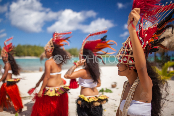Bora Bora, group of polynesian dancers with traditional costume on the beach