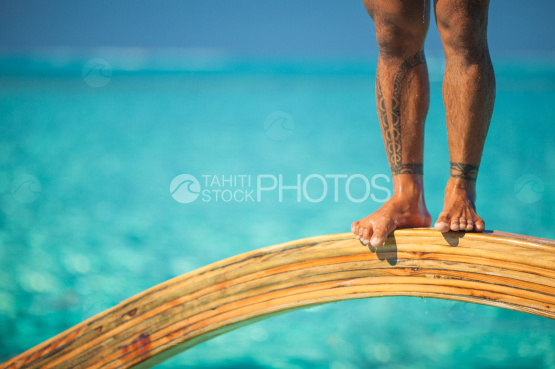 BORA BORA, polynesian standing on TRADITIONAL OUTRIGGER