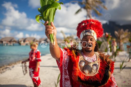 Polynesian preacher welcoming couple for taditional weeding on the beach, Bora Bora