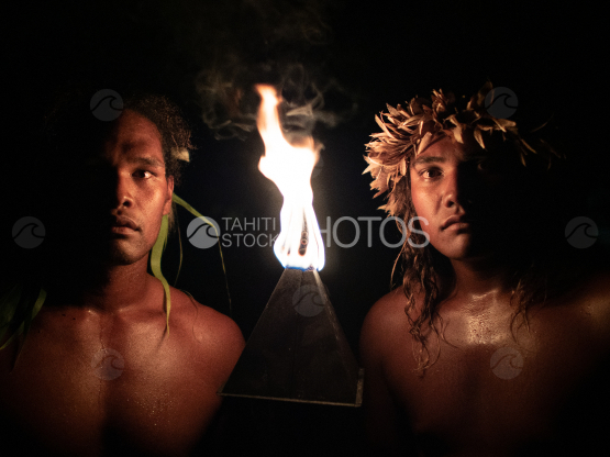 BORA BORA, PORTRAIT OF POLYNESIAN MEN WITH FIRE TORCH AT NIGHT