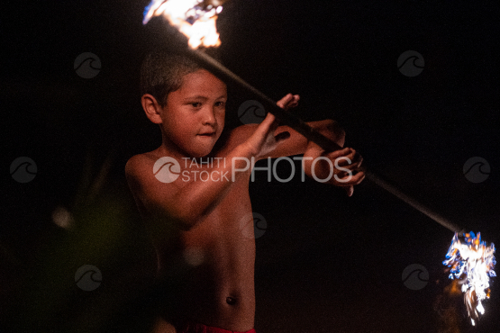 BORA BORA, PORTRAIT OF POLYNESIAN MEN WITH FIRE TORCH AT NIGHT