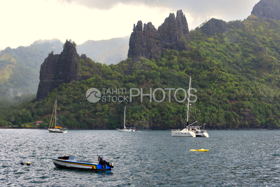 Sailboats anchored in the hatiheu bay, north of nuku hiva 
