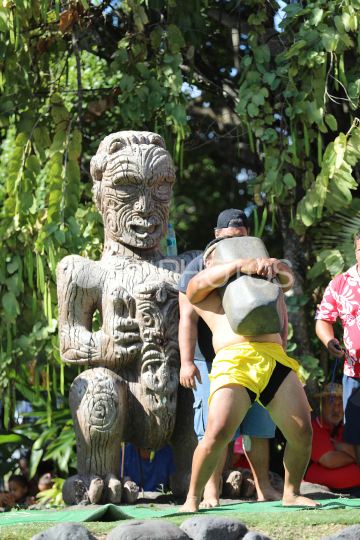 Tahiti, Man lifting a heavy stone, Stone lifting competition, Tuaro Maohi, Polynesia